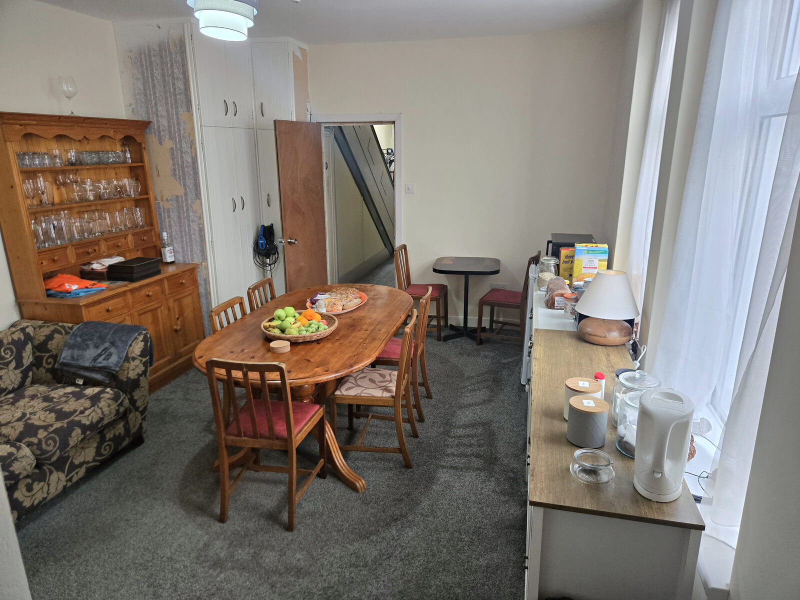 The dining room with a large wooden table and dresser